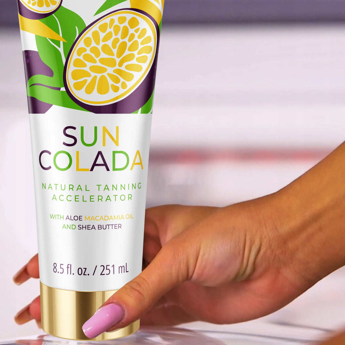 Zbliżenie dłoni trzymającej Onyx Suncolada. Naturalny przyspieszacz do opalania z masłem shea i olejem makadamia.