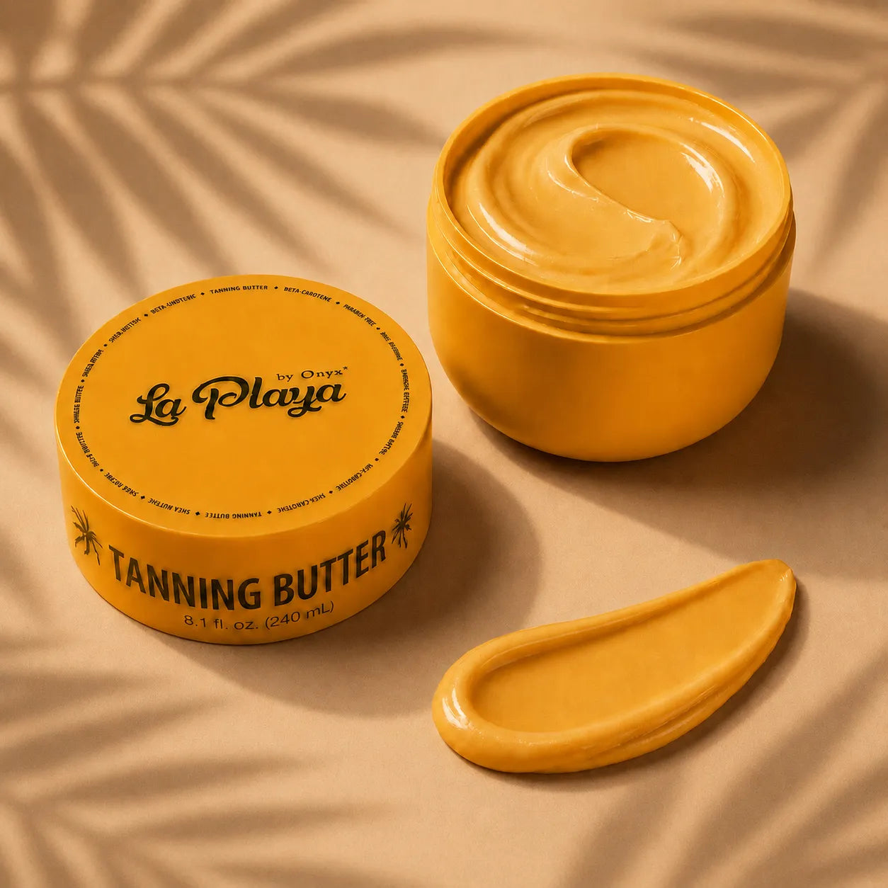 A jar of La Playa by Chava Tanning Butter shown open with a swirl of golden-yellow cream inside, alongside a dollop of the product on a beige surface with soft leaf shadows.